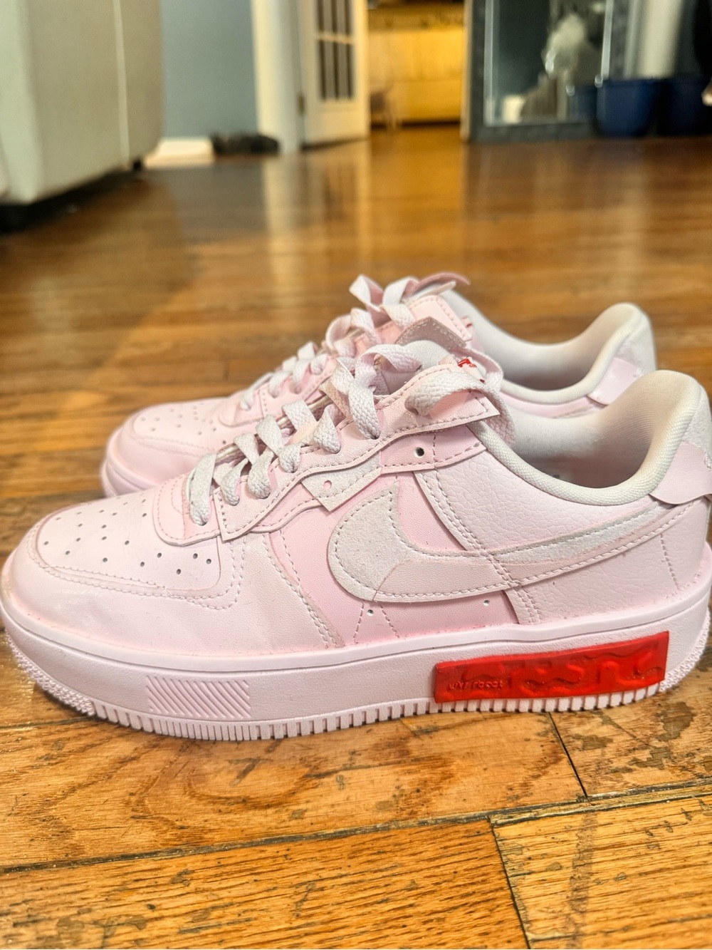 Nike Women’s Light Pink Air Force Sneakers with Red Accent